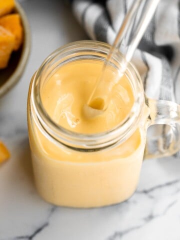 Healthy mango yogurt smoothie is refreshing, delicious, and healthy. Loaded with tropical mangos and low-fat yogurt, it's the perfect breakfast on the go. | aheadofthyme.com