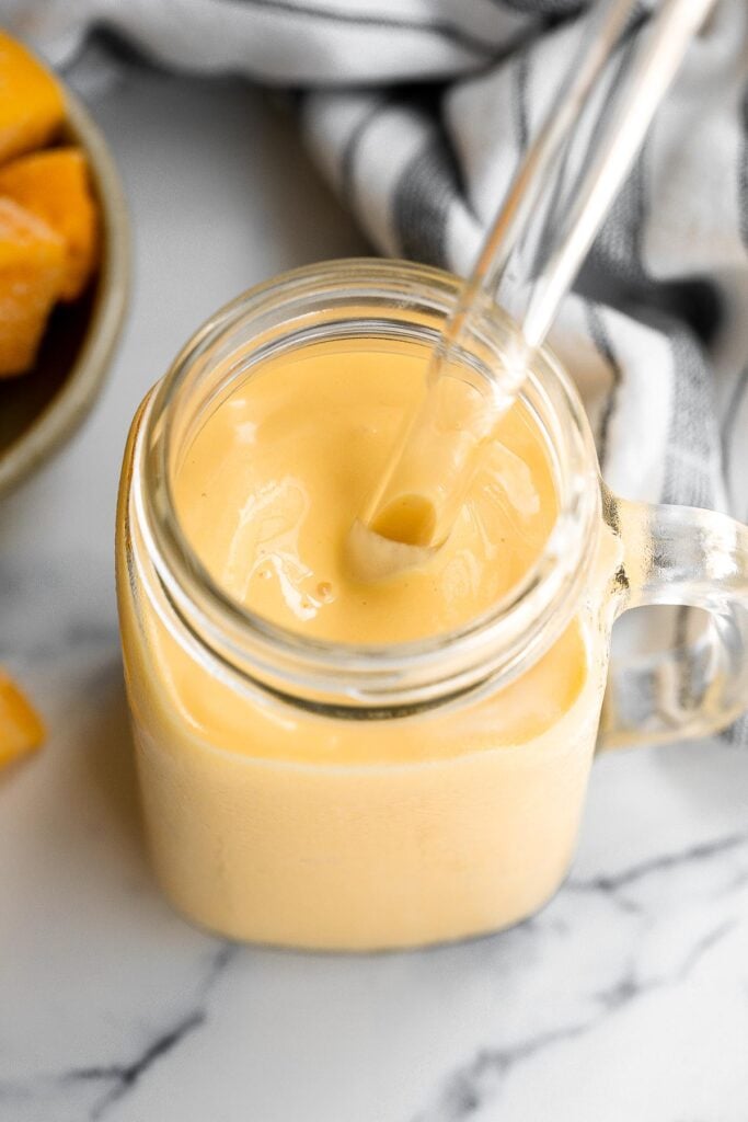 Healthy mango yogurt smoothie is refreshing, delicious, and healthy. Loaded with tropical mangos and low-fat yogurt, it's the perfect breakfast on the go. | aheadofthyme.com