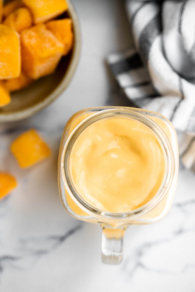 Healthy mango yogurt smoothie is refreshing, delicious, and healthy. Loaded with tropical mangos and low-fat yogurt, it's the perfect breakfast on the go. | aheadofthyme.com