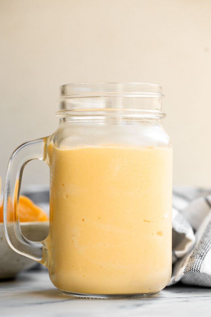 Healthy mango yogurt smoothie is refreshing, delicious, and healthy. Loaded with tropical mangos and low-fat yogurt, it's the perfect breakfast on the go. | aheadofthyme.com
