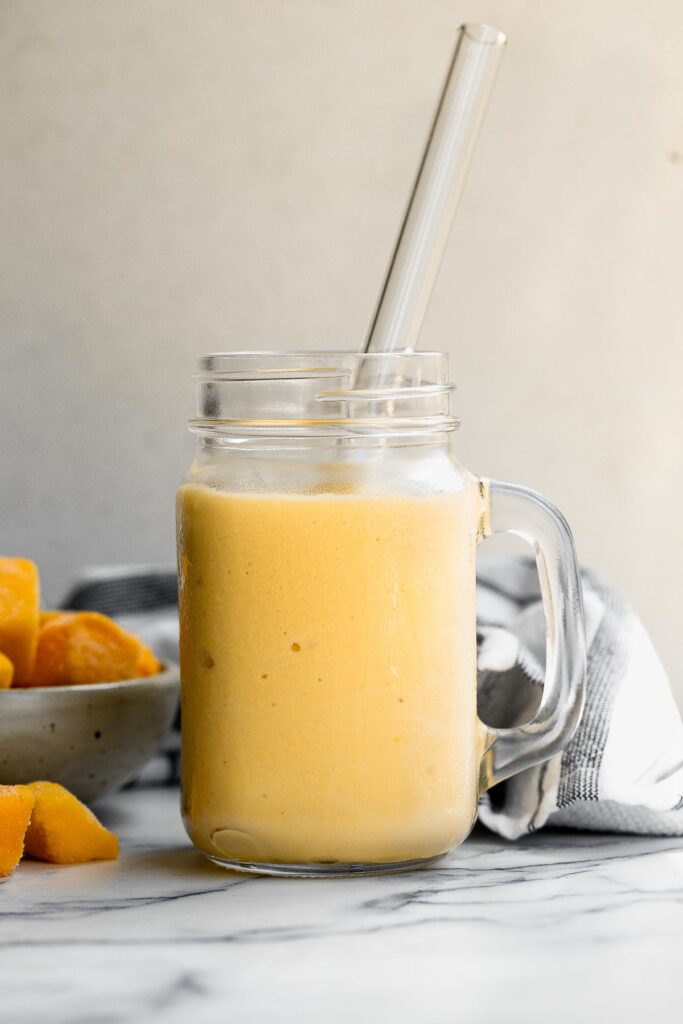 Healthy mango yogurt smoothie is refreshing, delicious, and healthy. Loaded with tropical mangos and low-fat yogurt, it's the perfect breakfast on the go. | aheadofthyme.com