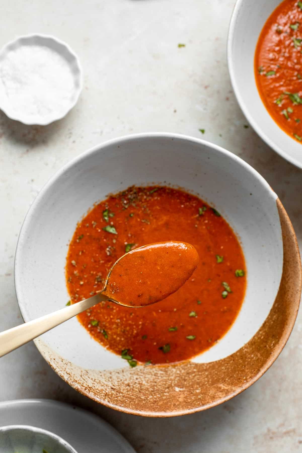 Roasted red pepper and tomato soup is silky smooth, incredibly flavorful and delicious, and easy to make. This vegan soup is healthy and nutritious too. | aheadofthyme.com