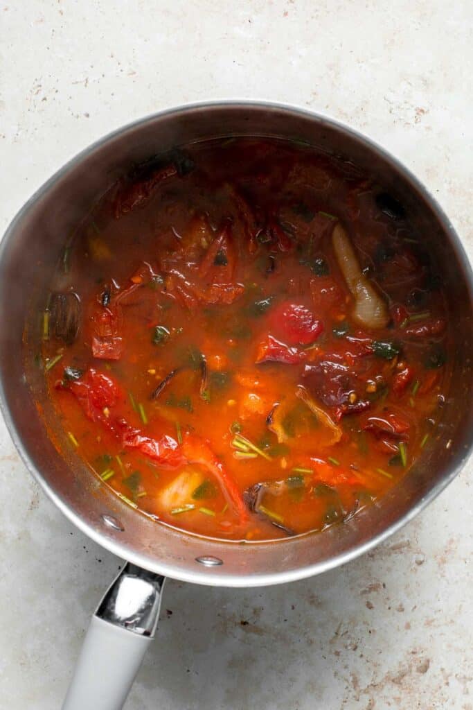 Roasted red pepper and tomato soup is silky smooth, incredibly flavorful and delicious, and easy to make. This vegan soup is healthy and nutritious too. | aheadofthyme.com