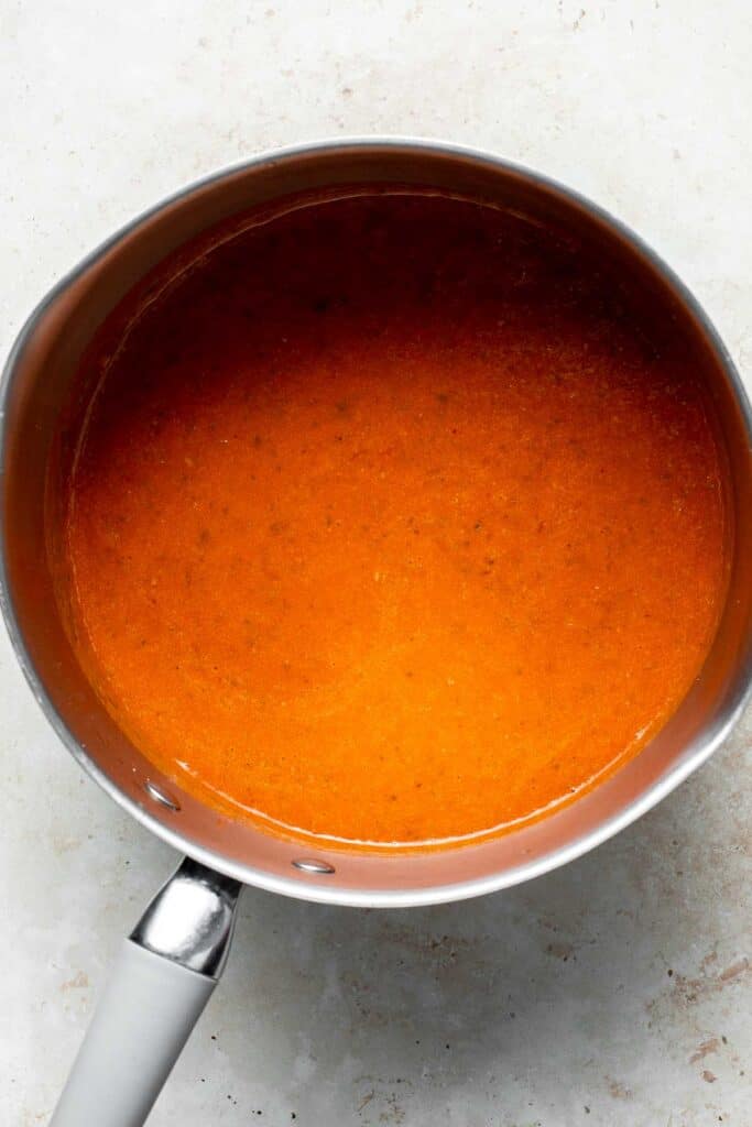 Roasted red pepper and tomato soup is silky smooth, incredibly flavorful and delicious, and easy to make. This vegan soup is healthy and nutritious too. | aheadofthyme.com