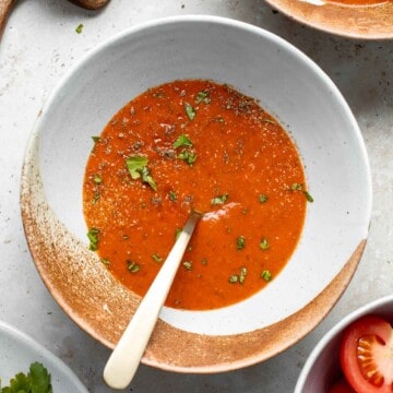 Roasted red pepper and tomato soup is silky smooth, incredibly flavorful and delicious, and easy to make. This vegan soup is healthy and nutritious too. | aheadofthyme.com
