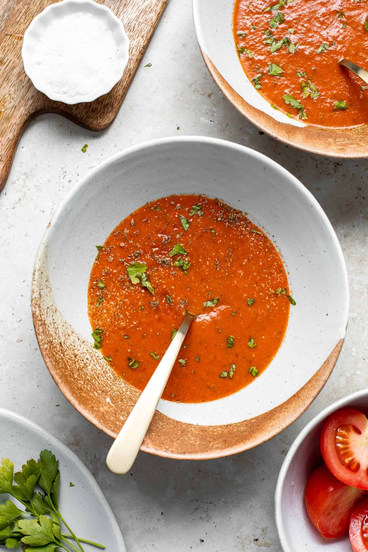 Roasted red pepper and tomato soup is silky smooth, incredibly flavorful and delicious, and easy to make. This vegan soup is healthy and nutritious too. | aheadofthyme.com