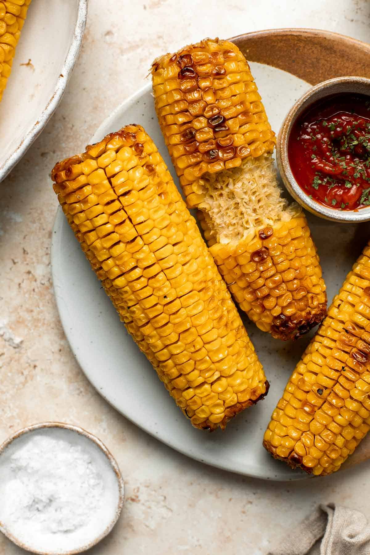 Oven-roasted corn on the cob with homemade garlic butter is buttery, juicy, crunchy, and perfectly charred on the outside — without a grill. | aheadofthyme.com