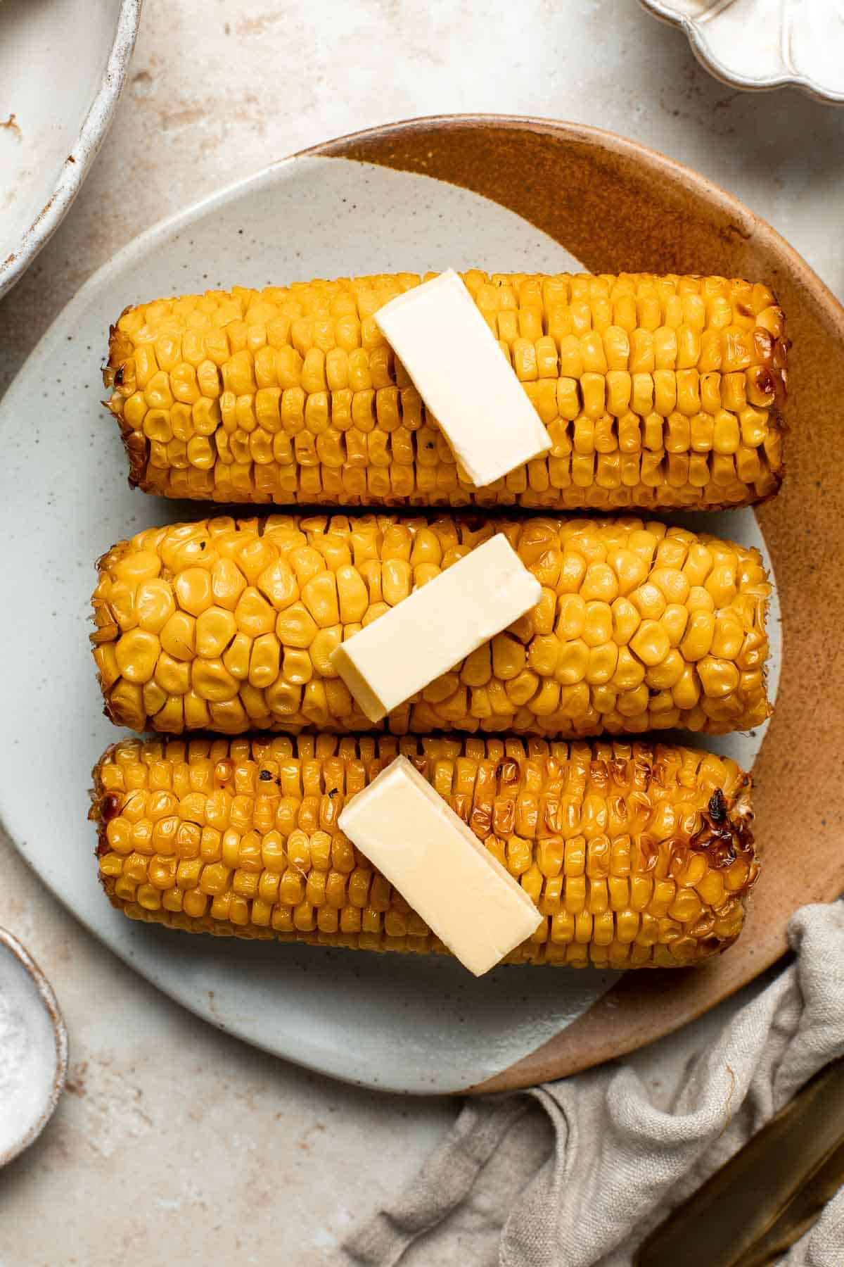 Oven-roasted corn on the cob with homemade garlic butter is buttery, juicy, crunchy, and perfectly charred on the outside — without a grill. | aheadofthyme.com