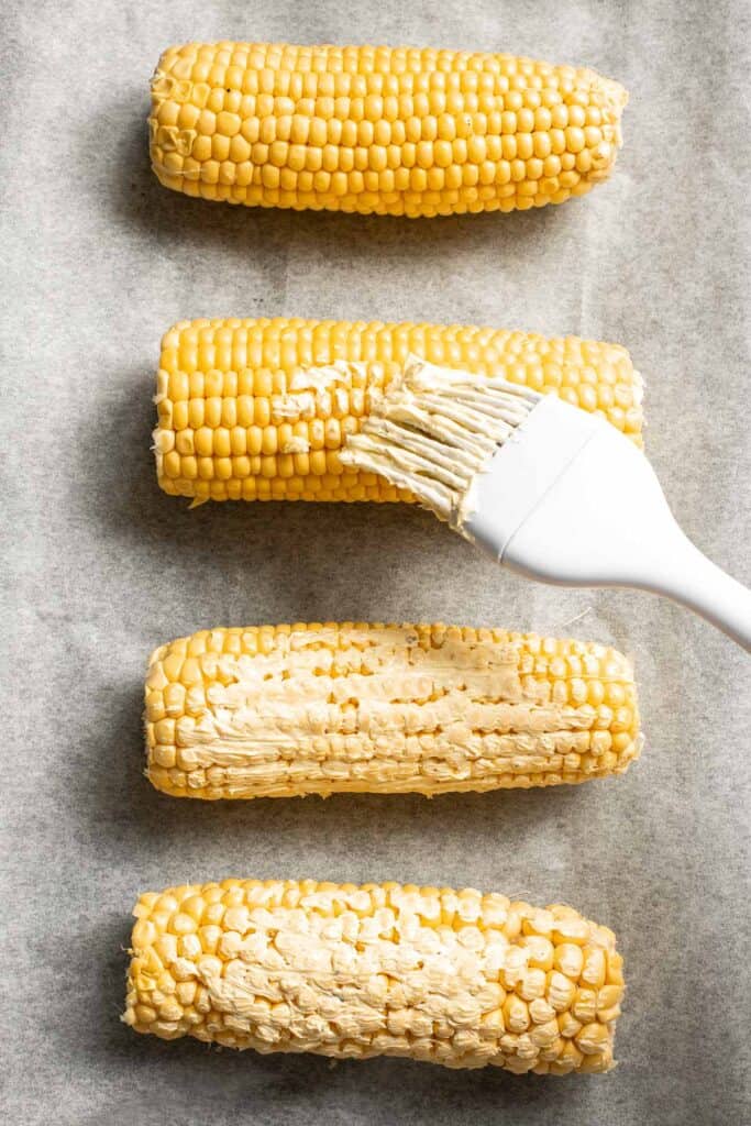 Oven-roasted corn on the cob with homemade garlic butter is buttery, juicy, crunchy, and perfectly charred on the outside — without a grill. | aheadofthyme.com