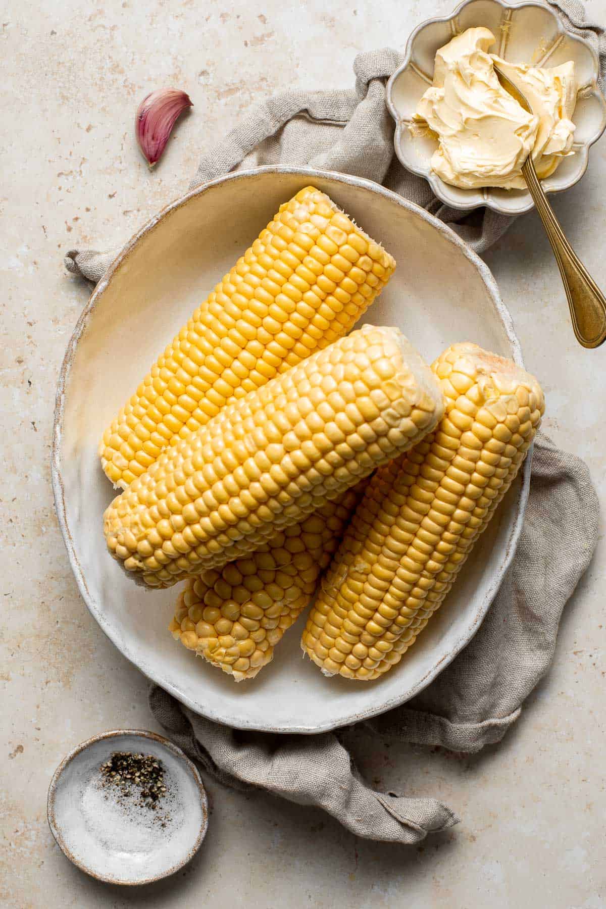 Oven-roasted corn on the cob with homemade garlic butter is buttery, juicy, crunchy, and perfectly charred on the outside — without a grill. | aheadofthyme.com