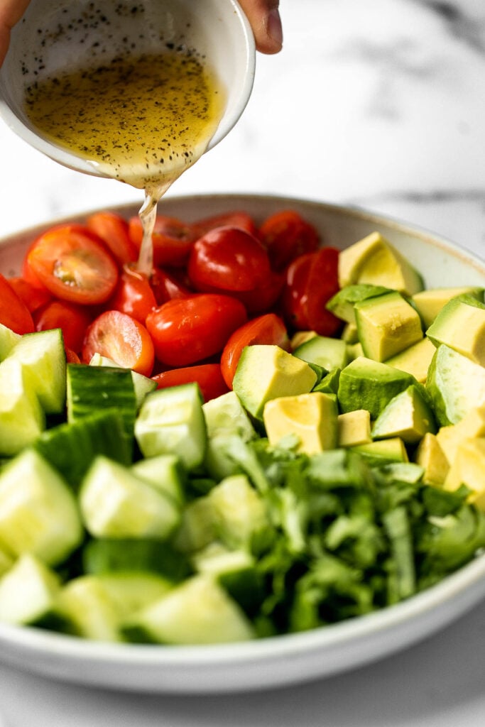 Simple tomato cucumber avocado salad with a delicious lemon vinaigrette is a light and refreshing salad that comes together in literally 5 minutes. | aheadofthyme.com