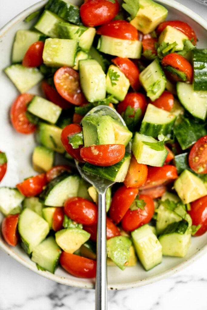 Simple tomato cucumber avocado salad with a delicious lemon vinaigrette is a light and refreshing salad that comes together in literally 5 minutes. | aheadofthyme.com