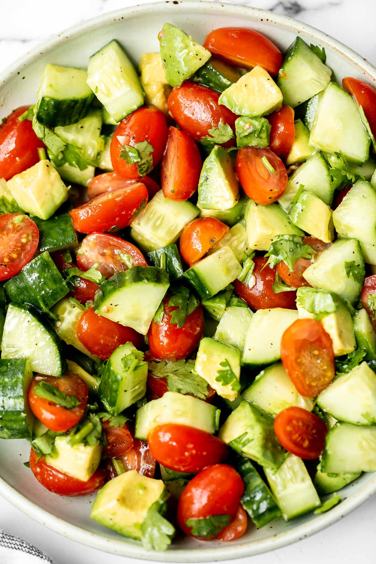 Simple tomato cucumber avocado salad with a delicious lemon vinaigrette is a light and refreshing salad that comes together in literally 5 minutes. | aheadofthyme.com