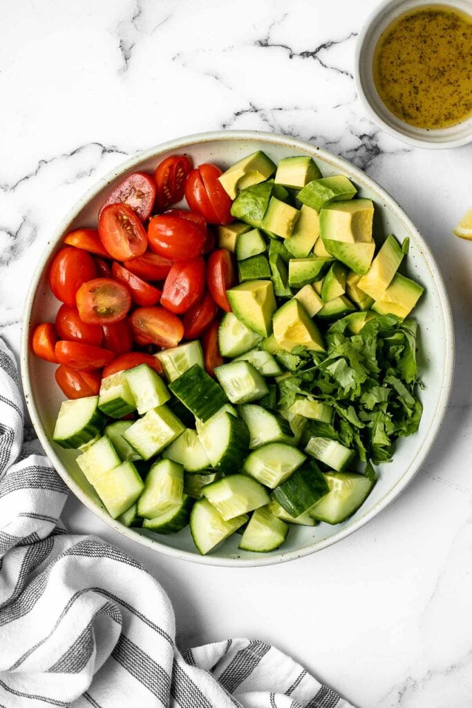 Simple tomato cucumber avocado salad with a delicious lemon vinaigrette is a light and refreshing salad that comes together in literally 5 minutes. | aheadofthyme.com