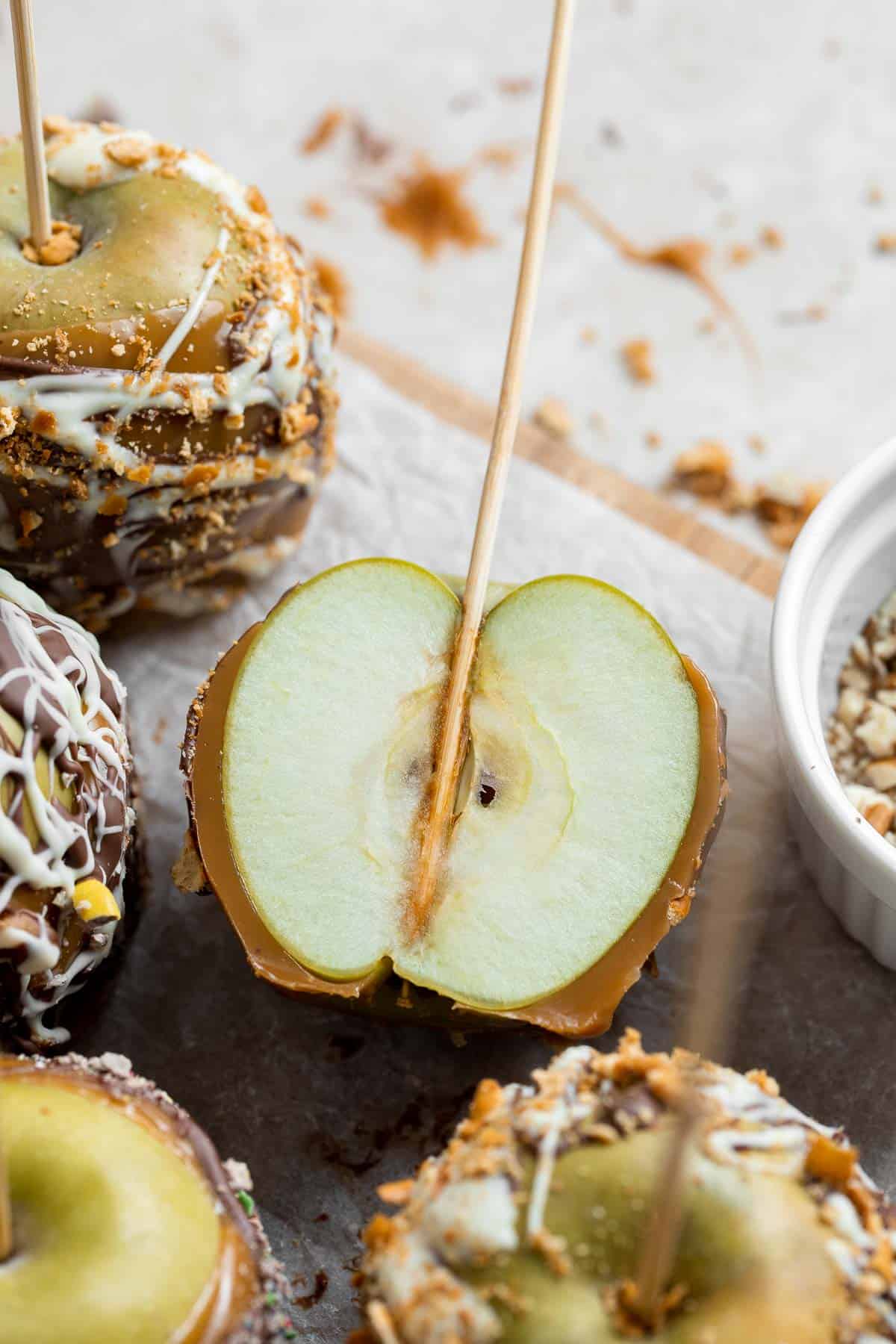 Homemade Caramel Apples are sweet, delicious, and fun to make. Chewy caramel made from scratch covers crisp juicy apples, topped with optional toppings. | aheadofthyme.com