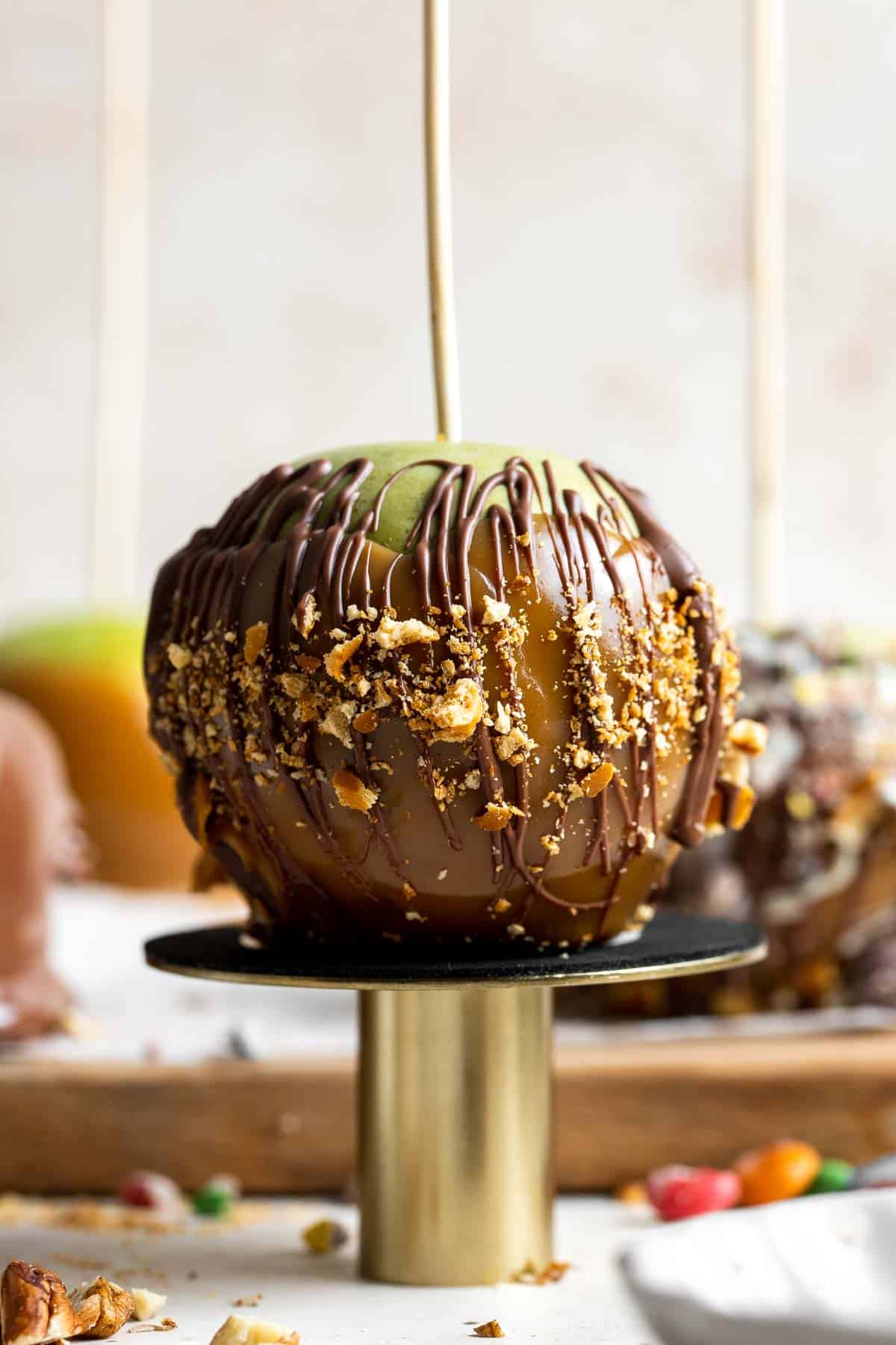 Homemade Caramel Apples are sweet, delicious, and fun to make. Chewy caramel made from scratch covers crisp juicy apples, topped with optional toppings. | aheadofthyme.com