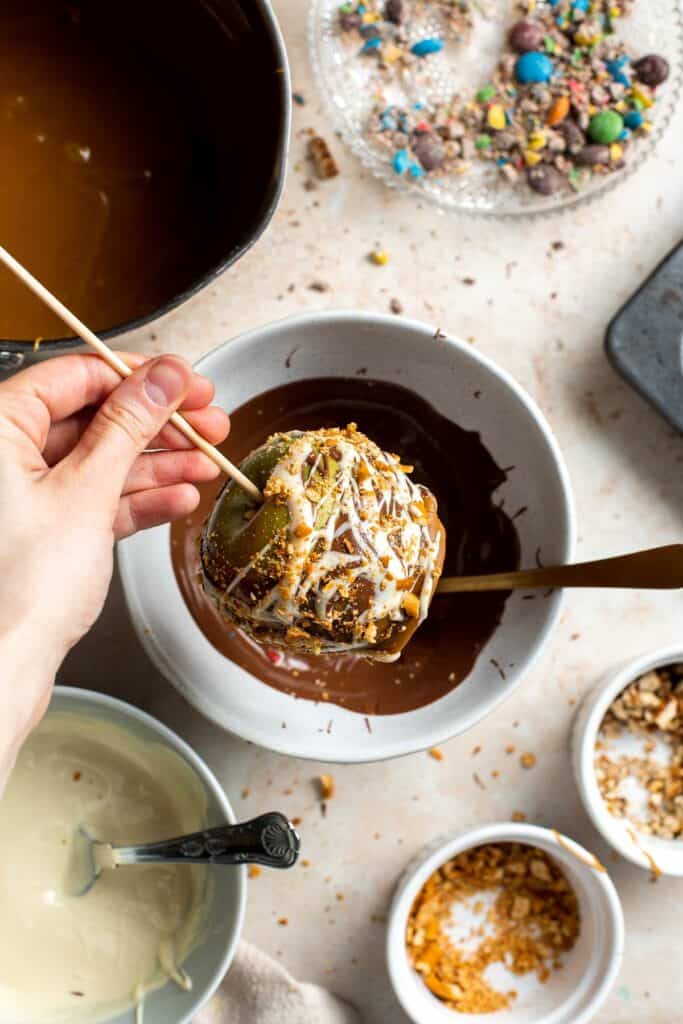 Homemade Caramel Apples are sweet, delicious, and fun to make. Chewy caramel made from scratch covers crisp juicy apples, topped with optional toppings. | aheadofthyme.com