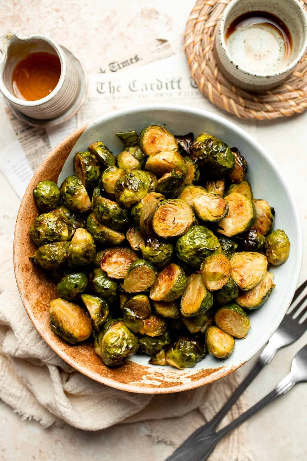 Tender and caramelized, these easy Roasted Brussels Sprouts tossed in balsamic vinegar and honey are a classic side dish to serve on your holiday table. | aheadofthyme.com