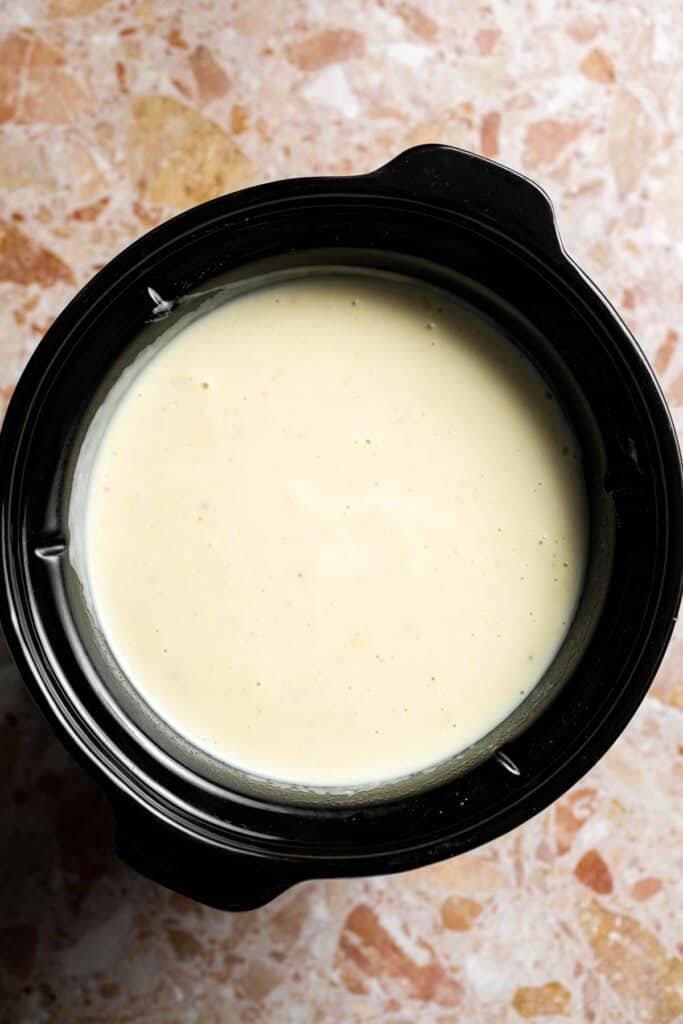 Creamy slow cooker loaded baked potato soup made with tender potatoes, cheddar cheese, sour cream, and topped with bacon. An easy comfort food recipe. | aheadofthyme.com