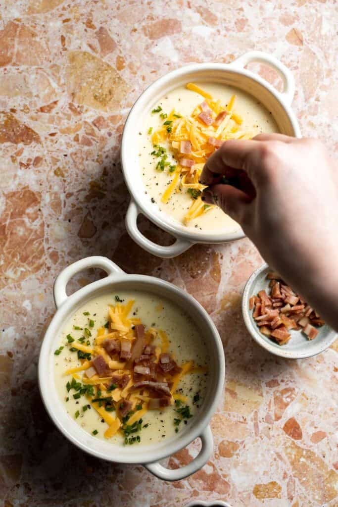 Creamy slow cooker loaded baked potato soup made with tender potatoes, cheddar cheese, sour cream, and topped with bacon. An easy comfort food recipe. | aheadofthyme.com