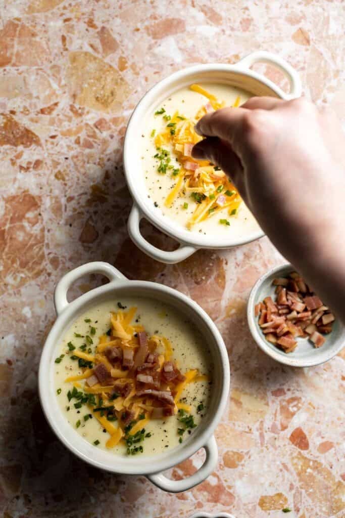 Creamy slow cooker loaded baked potato soup made with tender potatoes, cheddar cheese, sour cream, and topped with bacon. An easy comfort food recipe. | aheadofthyme.com