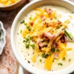 Creamy slow cooker loaded baked potato soup made with tender potatoes, cheddar cheese, sour cream, and topped with bacon. An easy comfort food recipe. | aheadofthyme.com