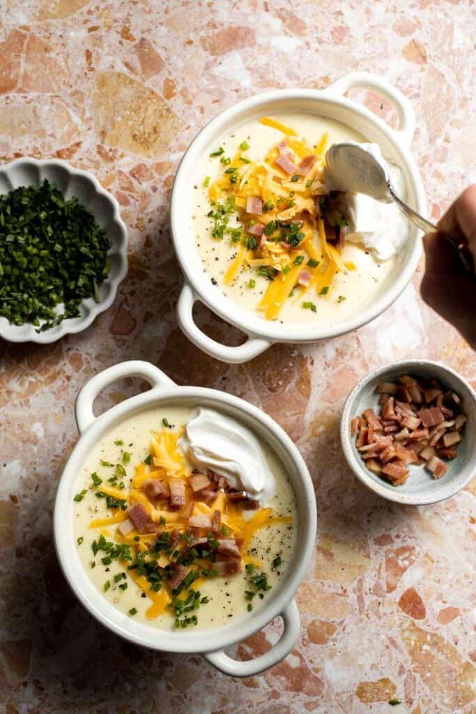 Creamy slow cooker loaded baked potato soup made with tender potatoes, cheddar cheese, sour cream, and topped with bacon. An easy comfort food recipe. | aheadofthyme.com