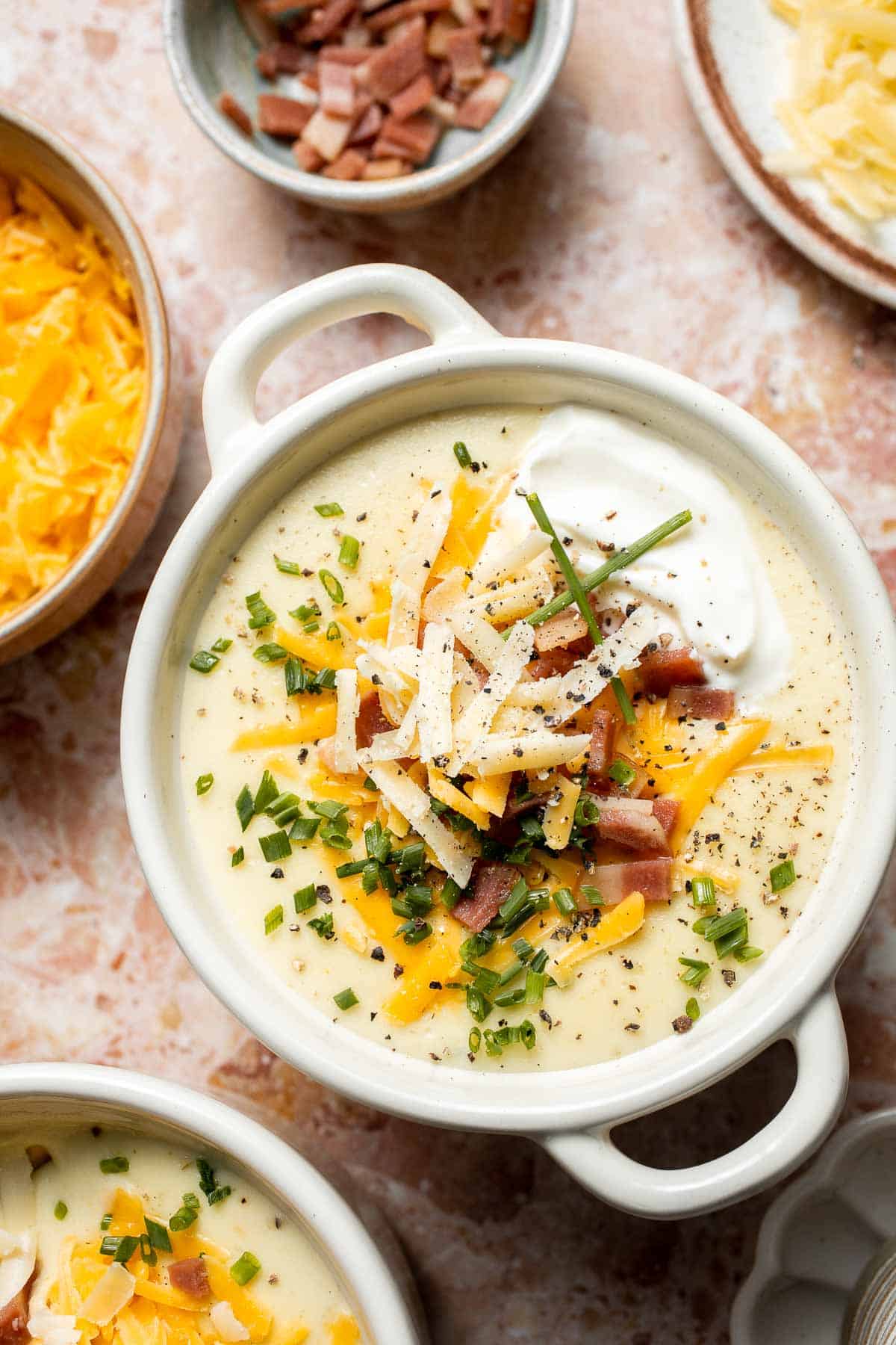 Creamy slow cooker loaded baked potato soup made with tender potatoes, cheddar cheese, sour cream, and topped with bacon. An easy comfort food recipe. | aheadofthyme.com