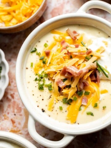 Creamy slow cooker loaded baked potato soup made with tender potatoes, cheddar cheese, sour cream, and topped with bacon. An easy comfort food recipe. | aheadofthyme.com