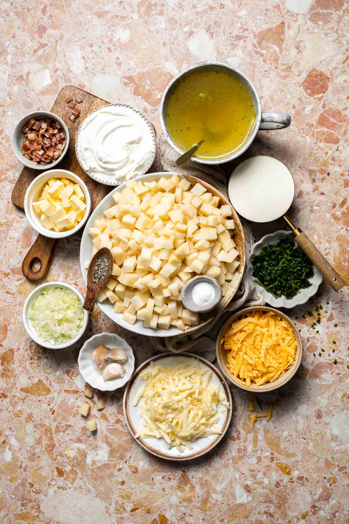 Creamy slow cooker loaded baked potato soup made with tender potatoes, cheddar cheese, sour cream, and topped with bacon. An easy comfort food recipe. | aheadofthyme.com