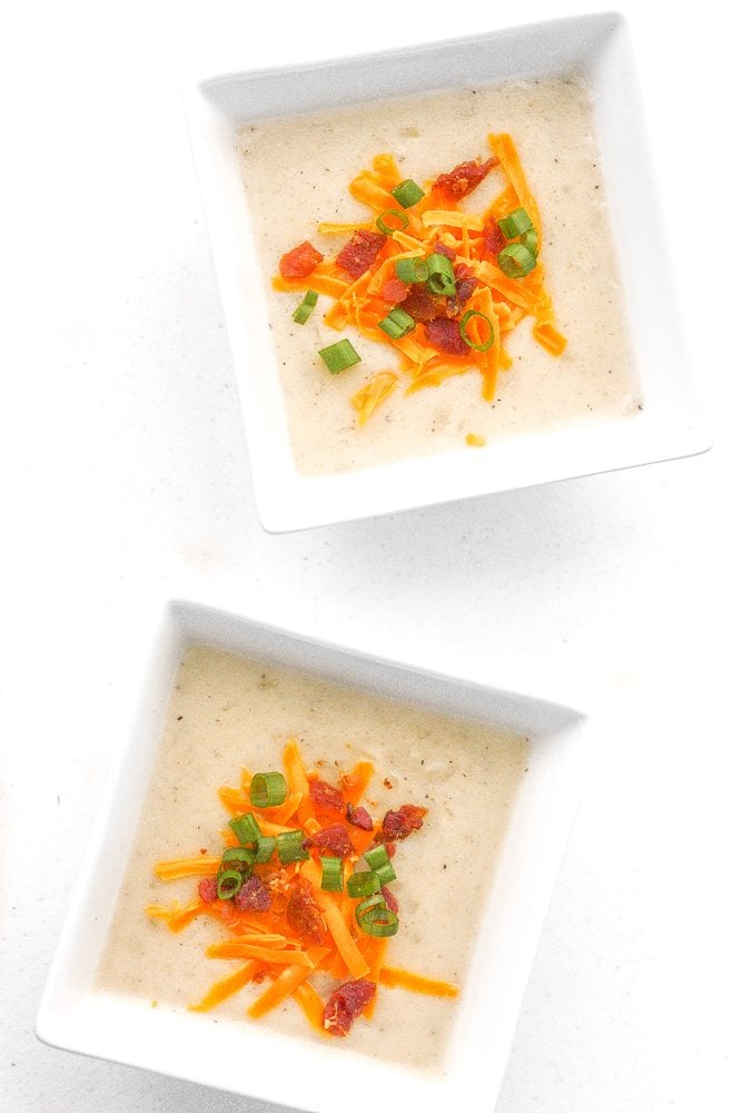 Nothing says comfort food like a bowl of slow cooker loaded baked potato soup topped with cheddar cheese, crumbled bacon and green onions. | aheadofthyme.com