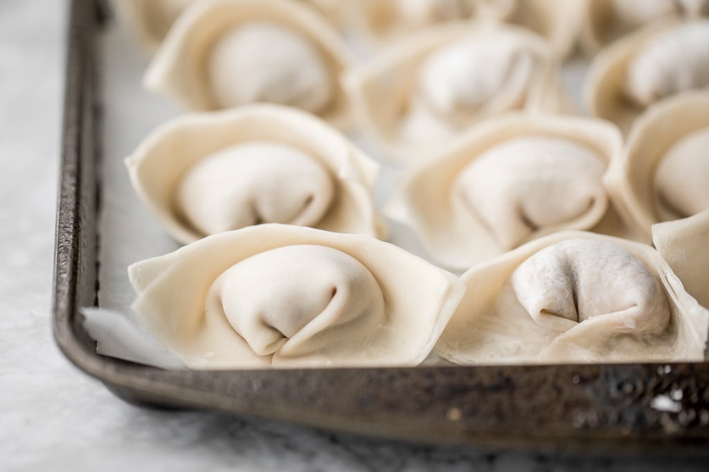 Learn how to make homemade chicken and cilantro wontons to celebrate Chinese new year with this easy to follow recipe and instructions on how to fold wontons. | aheadofthyme.com