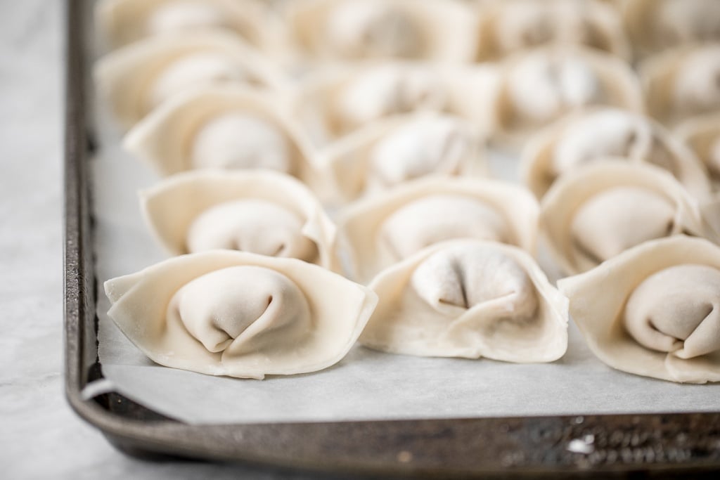 Learn how to make homemade chicken and cilantro wontons to celebrate Chinese new year with this easy to follow recipe and instructions on how to fold wontons. | aheadofthyme.com