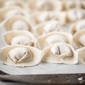 Learn how to make homemade chicken and cilantro wontons to celebrate Chinese new year with this easy to follow recipe and instructions on how to fold wontons. | aheadofthyme.com