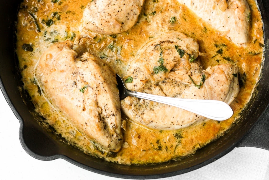 Delicious creamy skillet chicken with lemon garlic sauce is a one-skillet meal that is ready in 30 minutes. It's garlicky, saucy, creamy, and so flavourful. | aheadofthyme.com