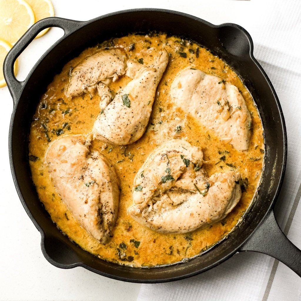 Delicious creamy skillet chicken with lemon garlic sauce is a one-skillet meal that is ready in 30 minutes. It's garlicky, saucy, creamy, and so flavourful. | aheadofthyme.com