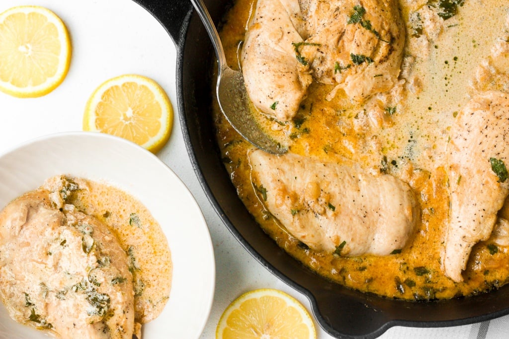 Delicious creamy skillet chicken with lemon garlic sauce is a one-skillet meal that is ready in 30 minutes. It's garlicky, saucy, creamy, and so flavourful. | aheadofthyme.com