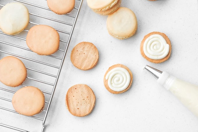 Easy French macarons with vanilla buttercream filling are sweet, light, airy, and delicate cookies that melt in your mouth. Beginners can make them too! | aheadofthyme.com