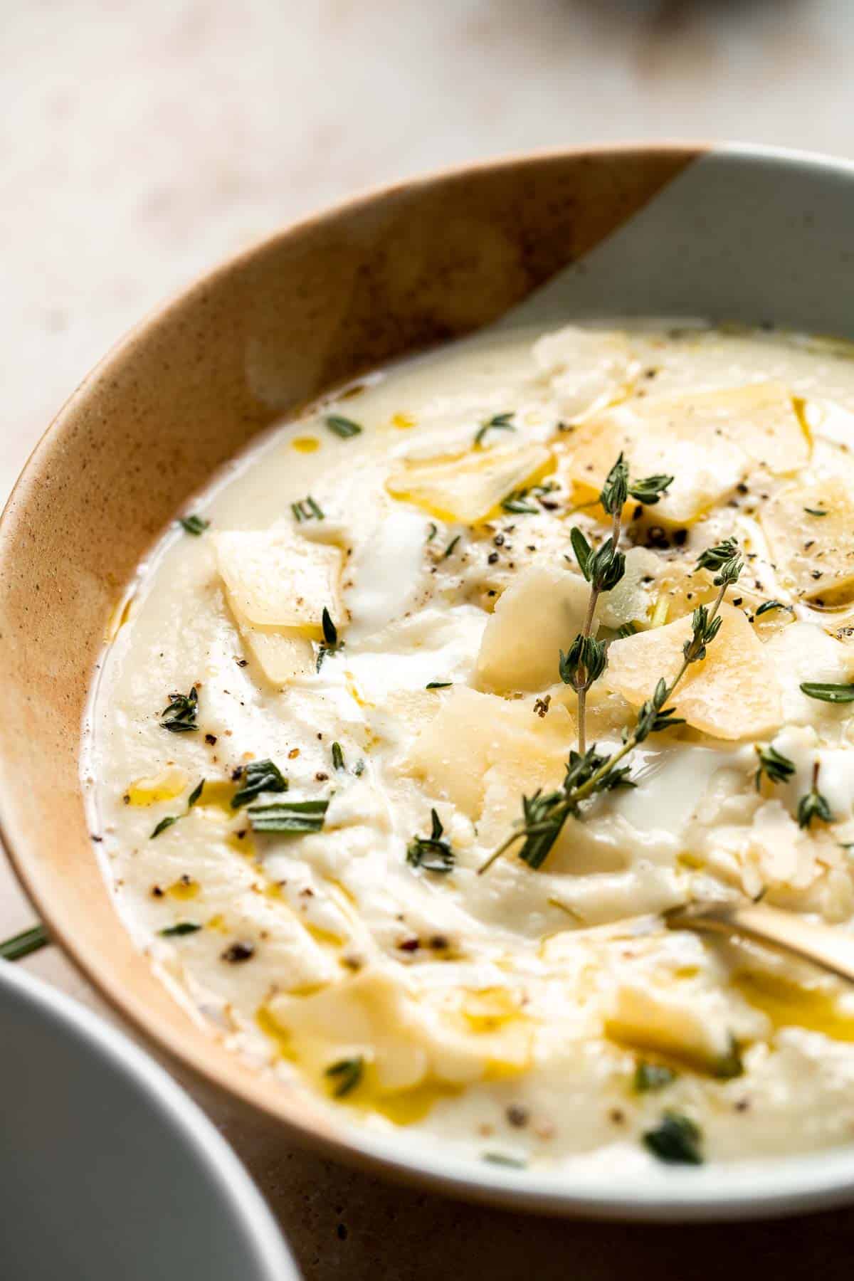 Creamy Garlic Cauliflower Soup is creamy and healthy. This vegetarian soup is ready in 45 minutes with a handful of wholesome ingredients and a few steps. | aheadofthyme.com