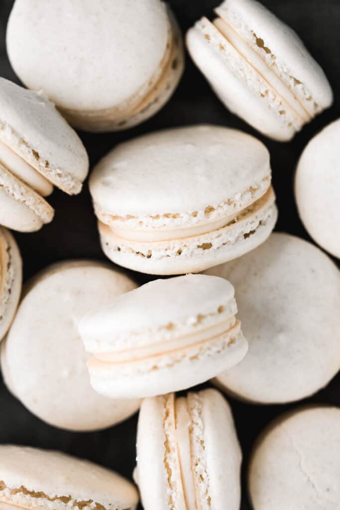 Easy French macarons with vanilla buttercream filling are sweet, light, airy, and delicate cookies that melt in your mouth. Beginners can make them too! | aheadofthyme.com