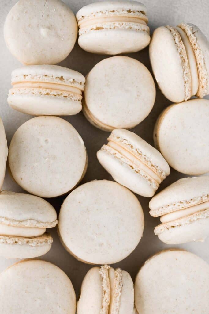 Easy French macarons with vanilla buttercream filling are sweet, light, airy, and delicate cookies that melt in your mouth. Beginners can make them too! | aheadofthyme.com