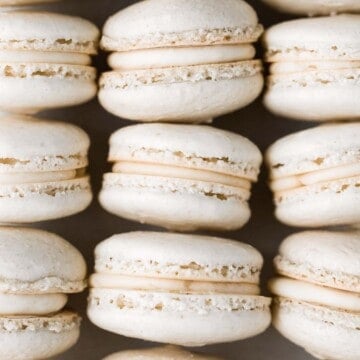 Easy French macarons with vanilla buttercream filling are sweet, light, airy, and delicate cookies that melt in your mouth. Beginners can make them too! | aheadofthyme.com