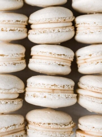 Easy French macarons with vanilla buttercream filling are sweet, light, airy, and delicate cookies that melt in your mouth. Beginners can make them too! | aheadofthyme.com