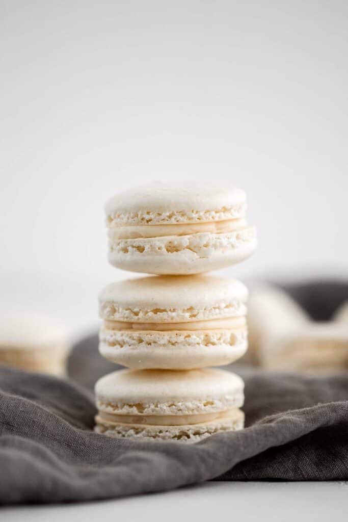 Easy French macarons with vanilla buttercream filling are sweet, light, airy, and delicate cookies that melt in your mouth. Beginners can make them too! | aheadofthyme.com