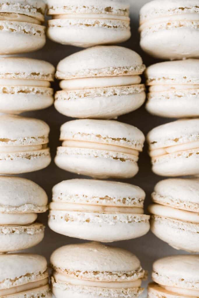 Easy French macarons with vanilla buttercream filling are sweet, light, airy, and delicate cookies that melt in your mouth. Beginners can make them too! | aheadofthyme.com