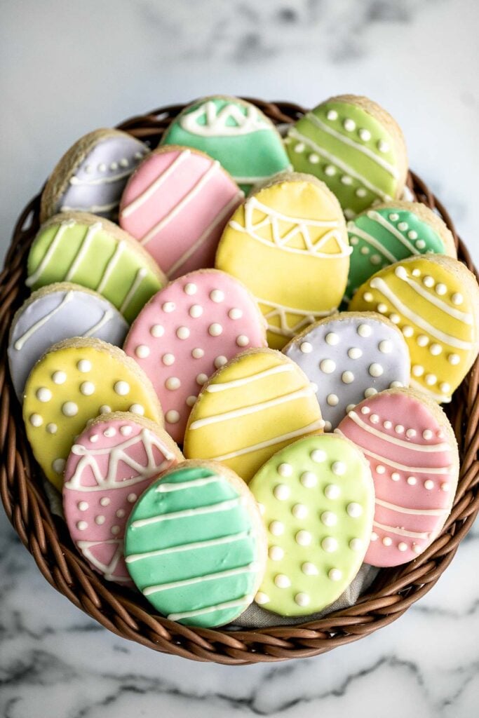 Cute, delicious, and easy-to-make Easter egg sugar cookies with royal icing are the perfect treat to make this Easter. Crisp outside and soft inside. | aheadofthyme.com