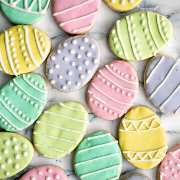 Cute, delicious, and easy-to-make Easter egg sugar cookies with royal icing are the perfect treat to make this Easter. Crisp outside and soft inside. | aheadofthyme.com