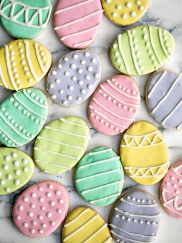 Cute, delicious, and easy-to-make Easter egg sugar cookies with royal icing are the perfect treat to make this Easter. Crisp outside and soft inside. | aheadofthyme.com