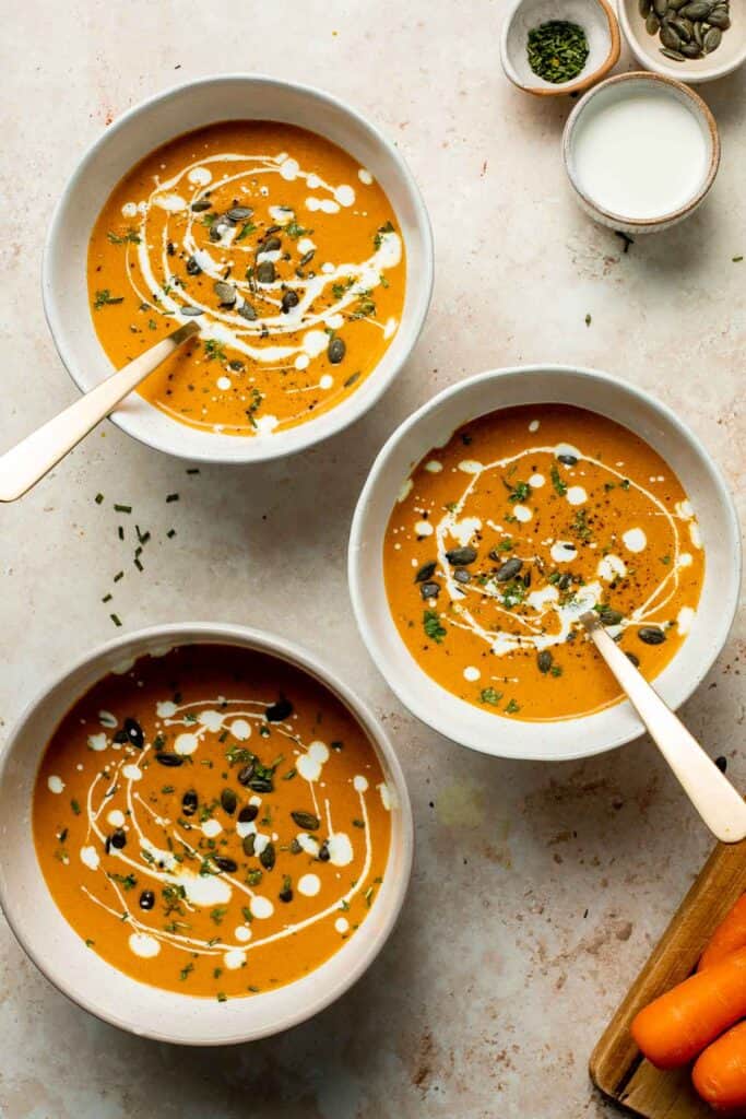 Roasted carrot and ginger soup is rich, velvety, creamy, flavorful, and delicious. This healthy vegetarian soup is quick and easy to make in 30 minutes. | aheadofthyme.com