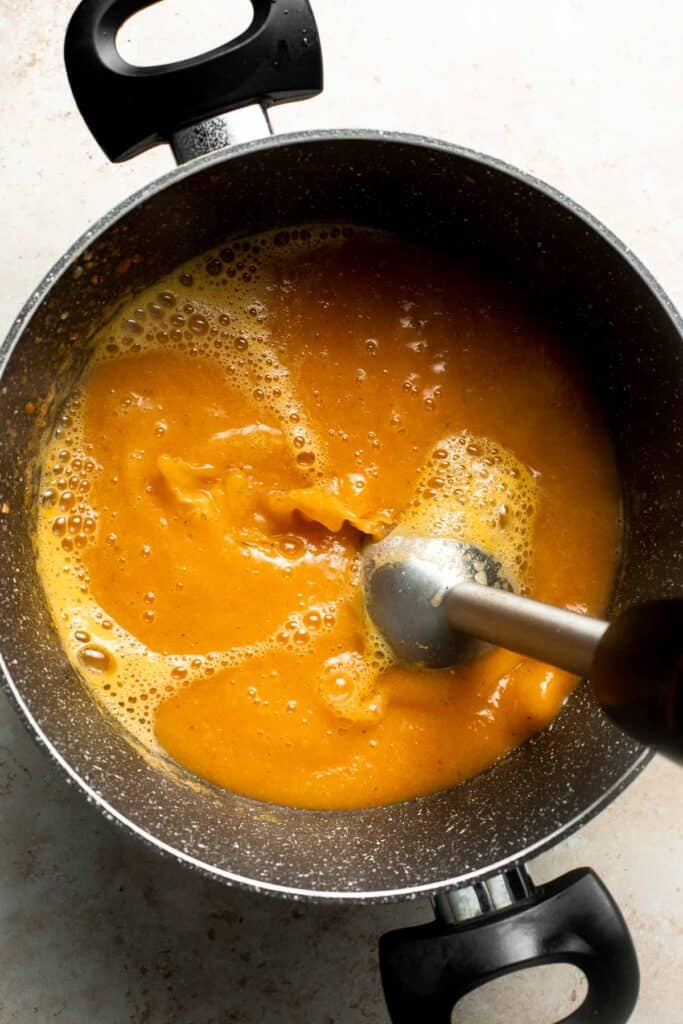 Roasted carrot and ginger soup is rich, velvety, creamy, flavorful, and delicious. This healthy vegetarian soup is quick and easy to make in 30 minutes. | aheadofthyme.com